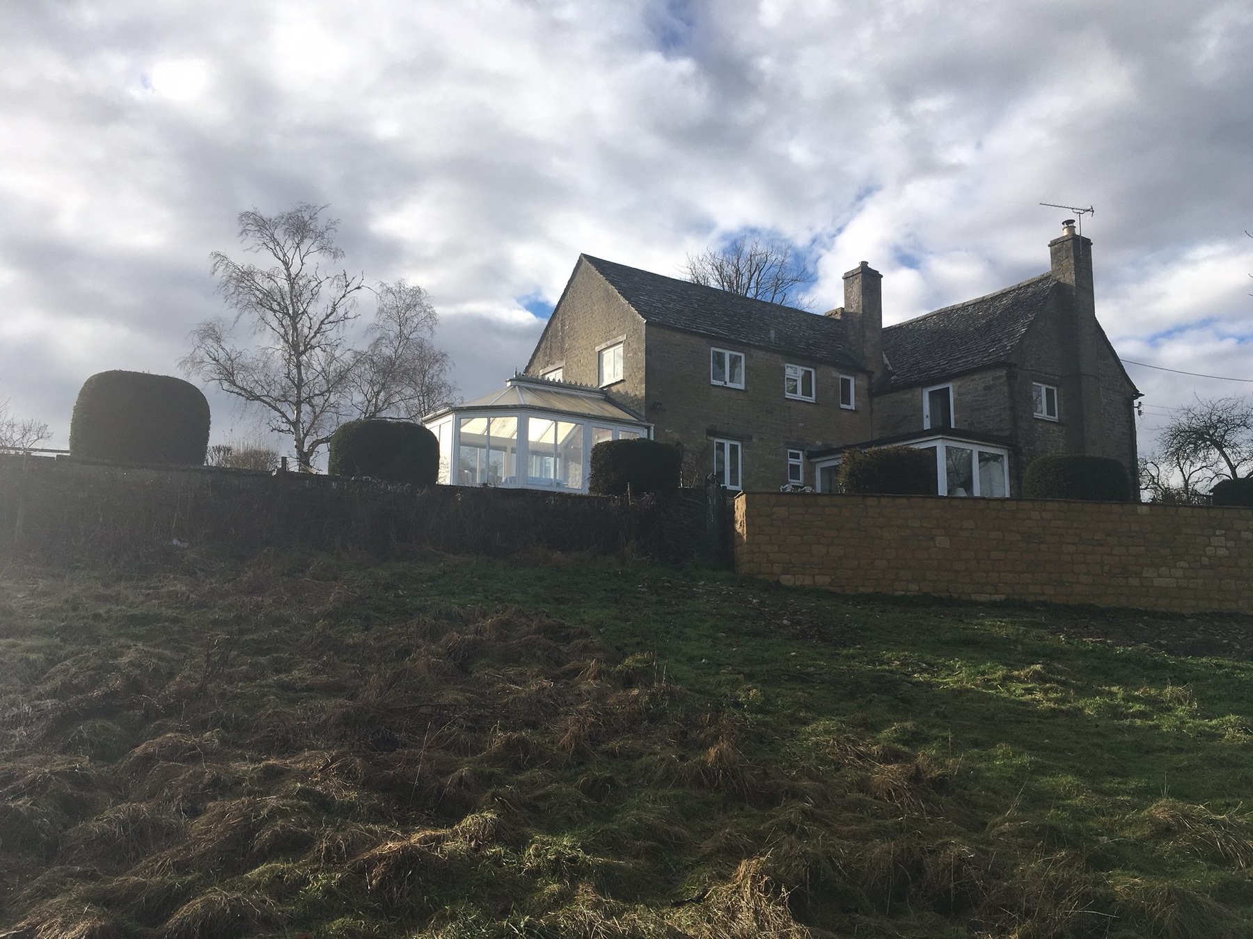 The farmhouse before — with the existing conservatory and extension